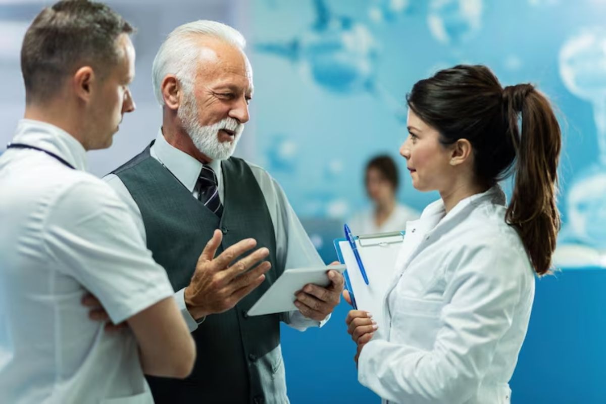 dentist discussing leadership strategies with dental team members in a professional setting.